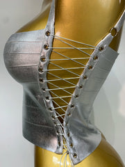 Side view of silver bandage corset top showcasing lace-up closure