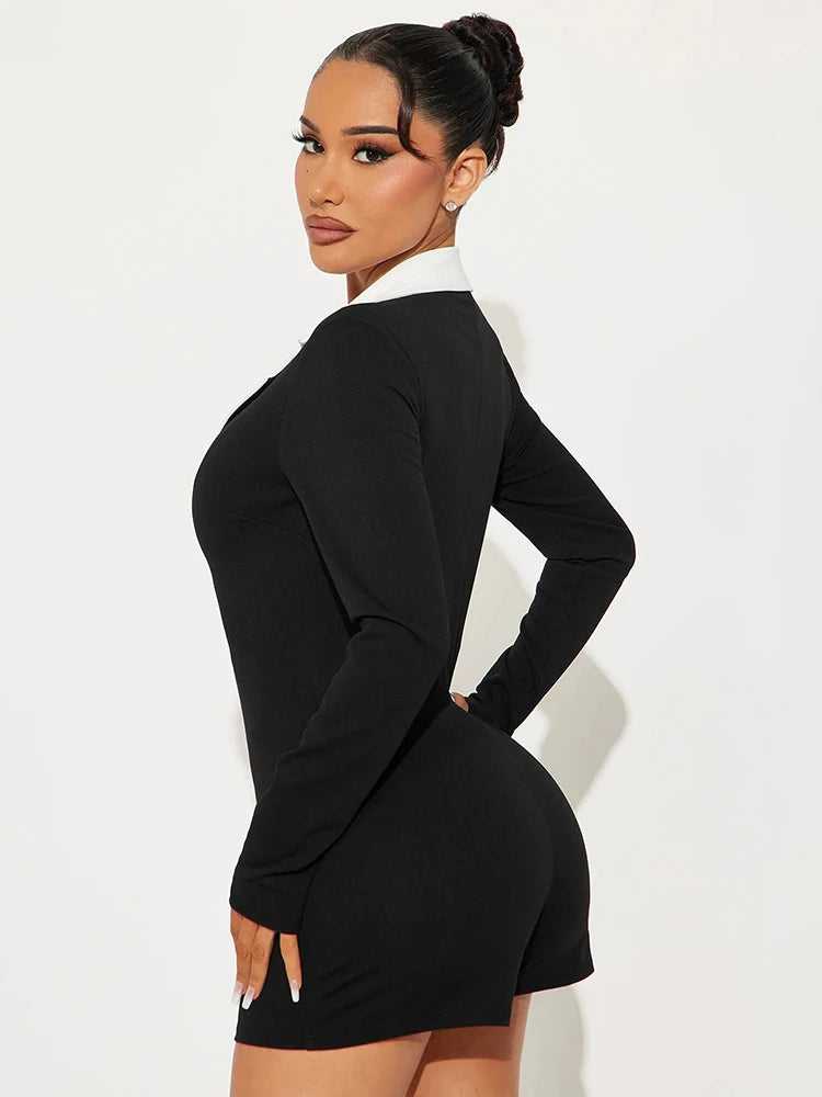 Woman wearing a black long-sleeve dress against a white background