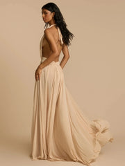 Woman wearing a flowing beige dress against a beige background