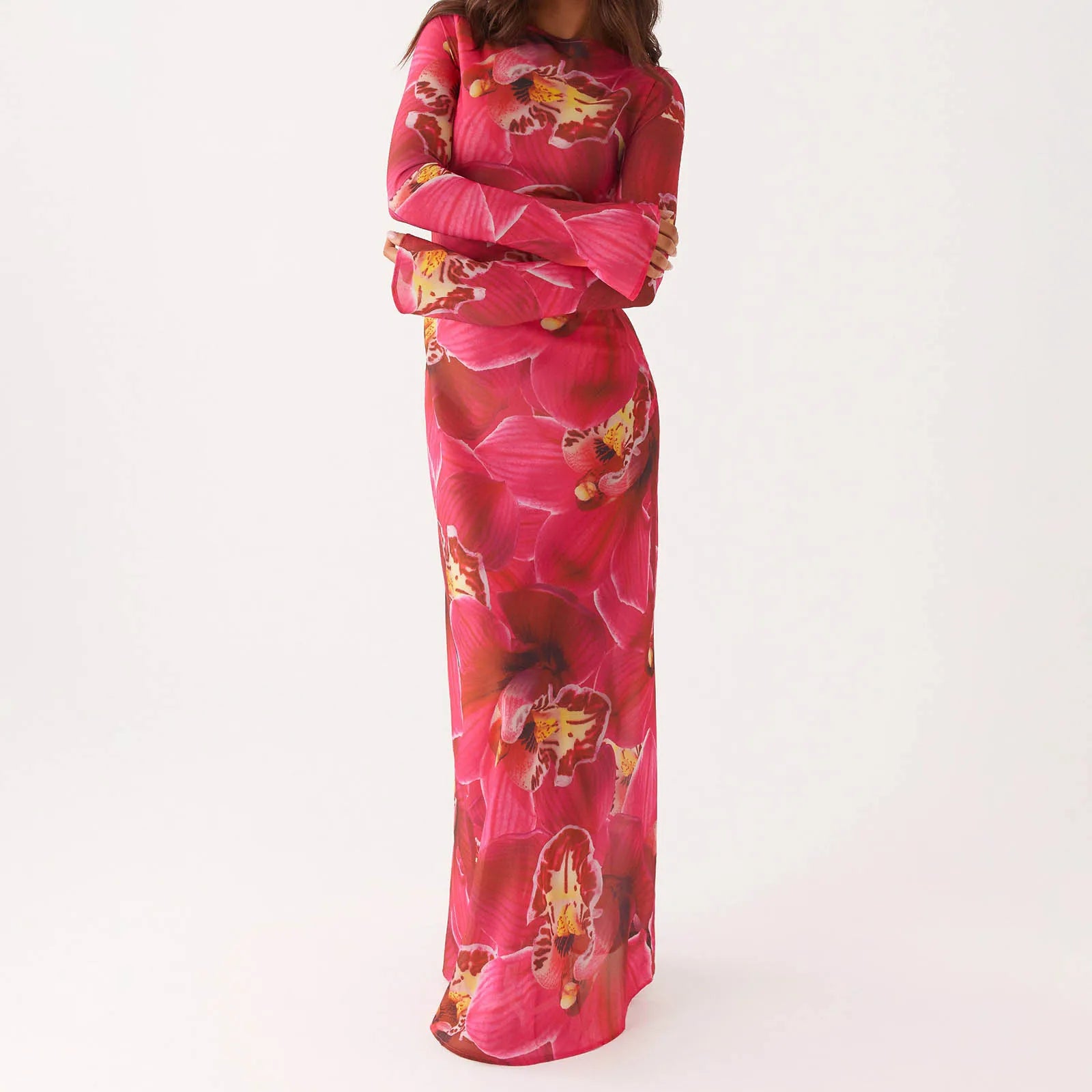 Person wearing a vibrant pink floral dress