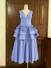 Light blue dress on a mannequin against a wooden door background