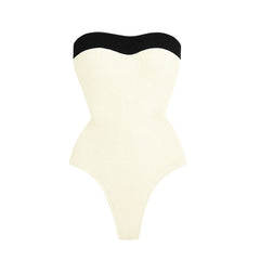 Textured cream swimsuit with black trim.