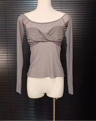Gray long-sleeve top with a glittery front on a mannequin against a dark background
