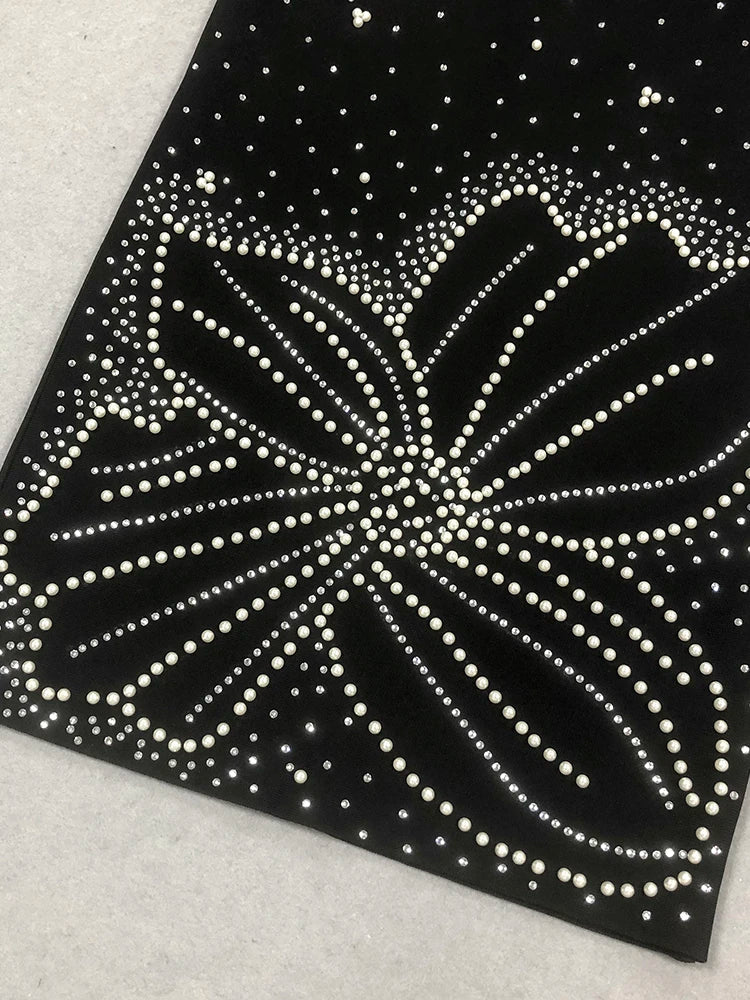 Black paper with white dot pattern on a textured surface
