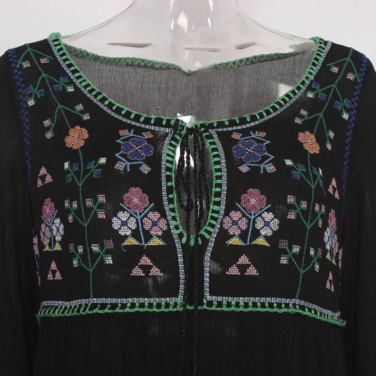 Black embroidered garment on a mannequin