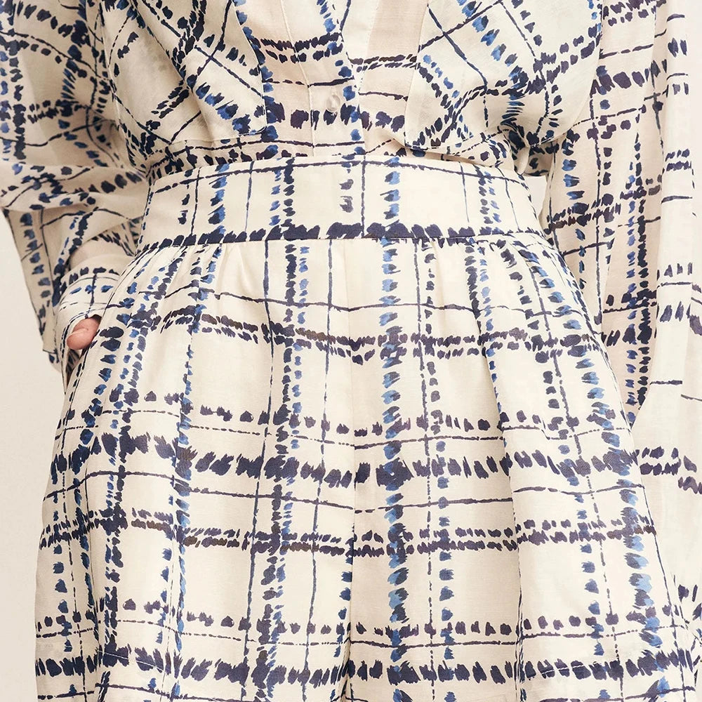 Plaid patterned garment with blue and white colors on a neutral background
