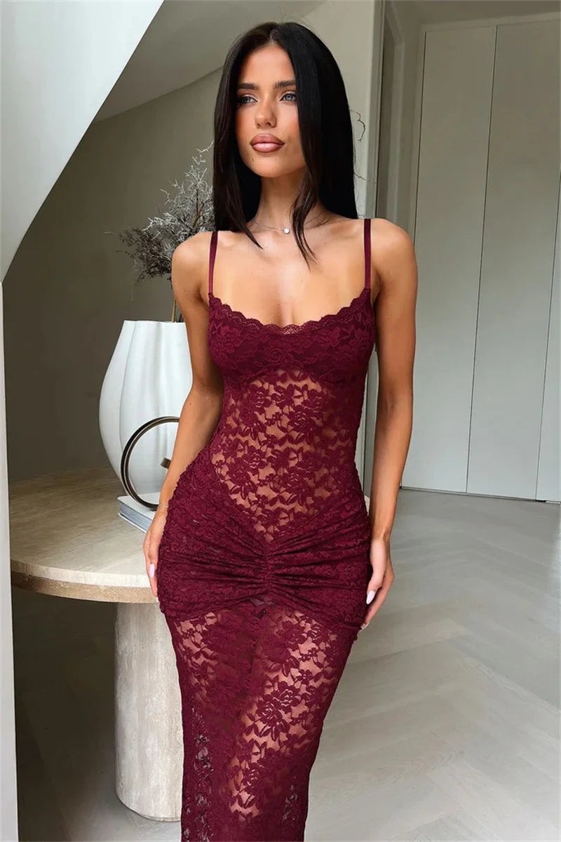 Woman wearing a burgundy lace dress in an indoor setting