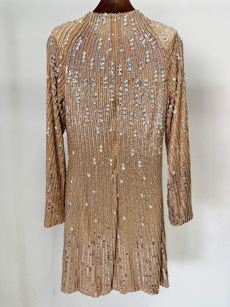Back view of a gold beaded long sleeve mini dress on a hanger.