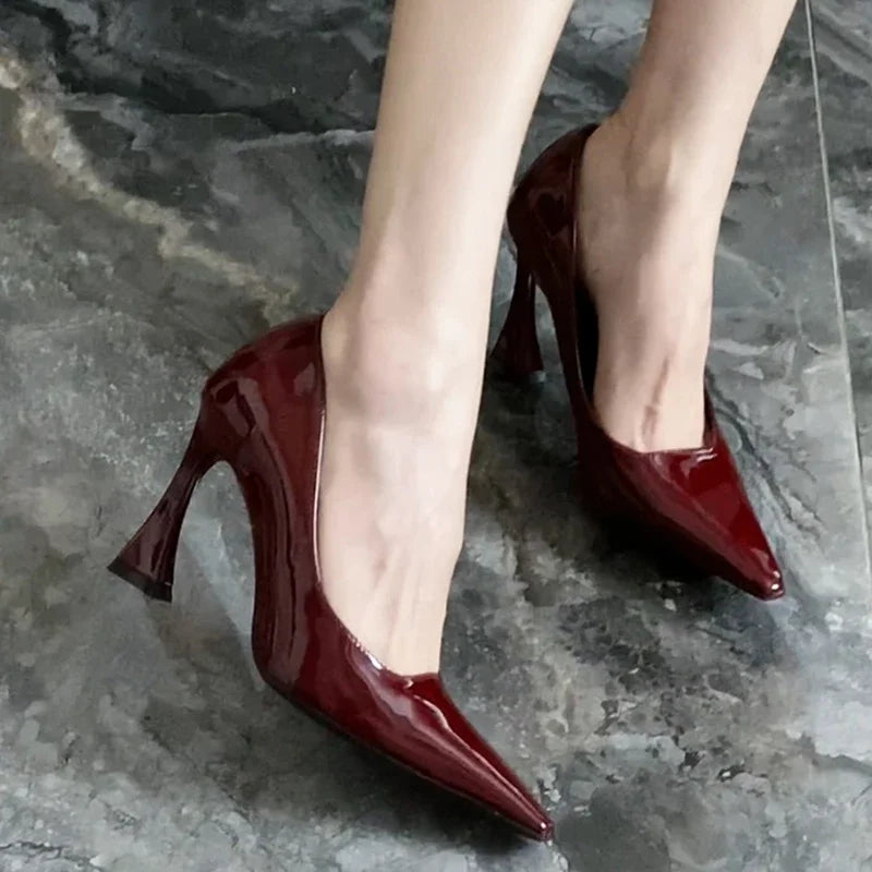 Red high-heeled shoes on a gray stone floor