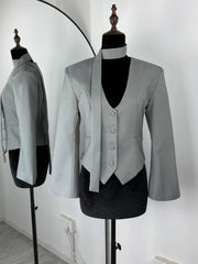 Gray blazer and vest set on mannequins against a white background