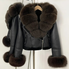 Black leather jacket with fur trim on a hanger against a white background