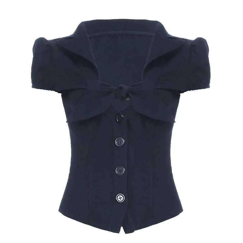 Navy blue top with a large bow on a white background