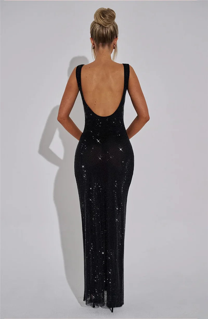 Black evening gown with open back on a plain background
