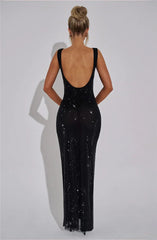 Black evening gown with open back on a plain background