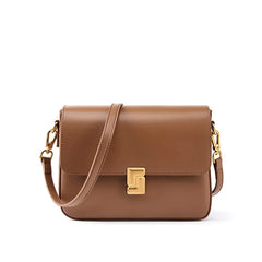 Brown leather handbag with gold accents on a white background