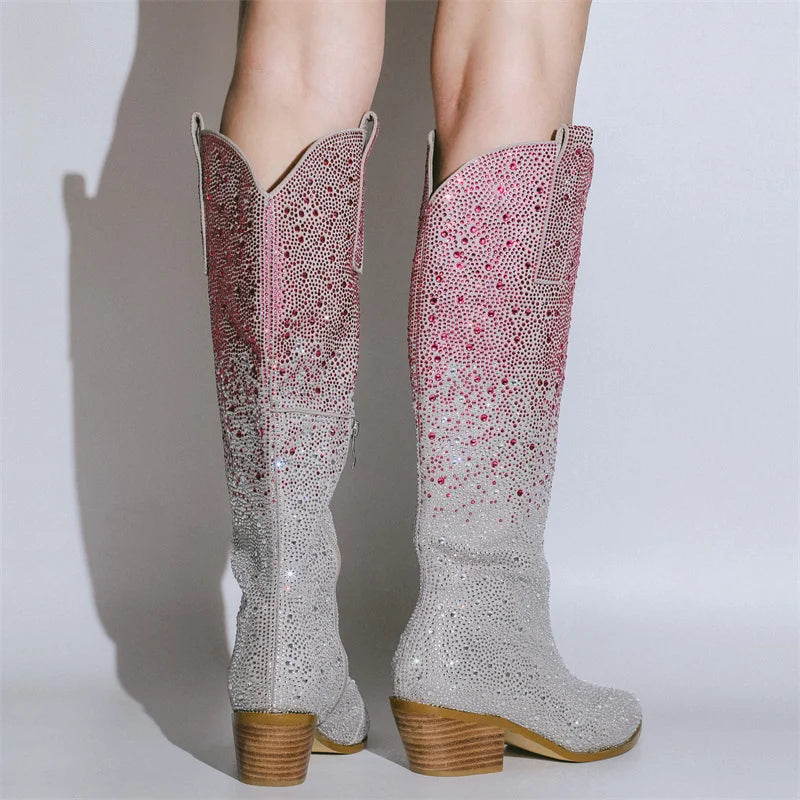 Sparkly cowboy boots with a gradient design on a plain background