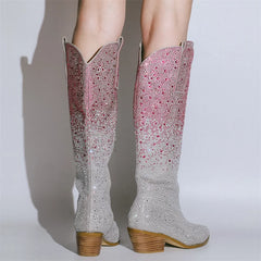 Sparkly cowboy boots with a gradient design on a plain background