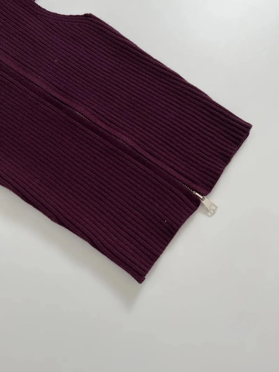 Maroon ribbed sweater with a zipper on a light gray background