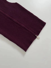 Maroon ribbed sweater with a zipper on a light gray background