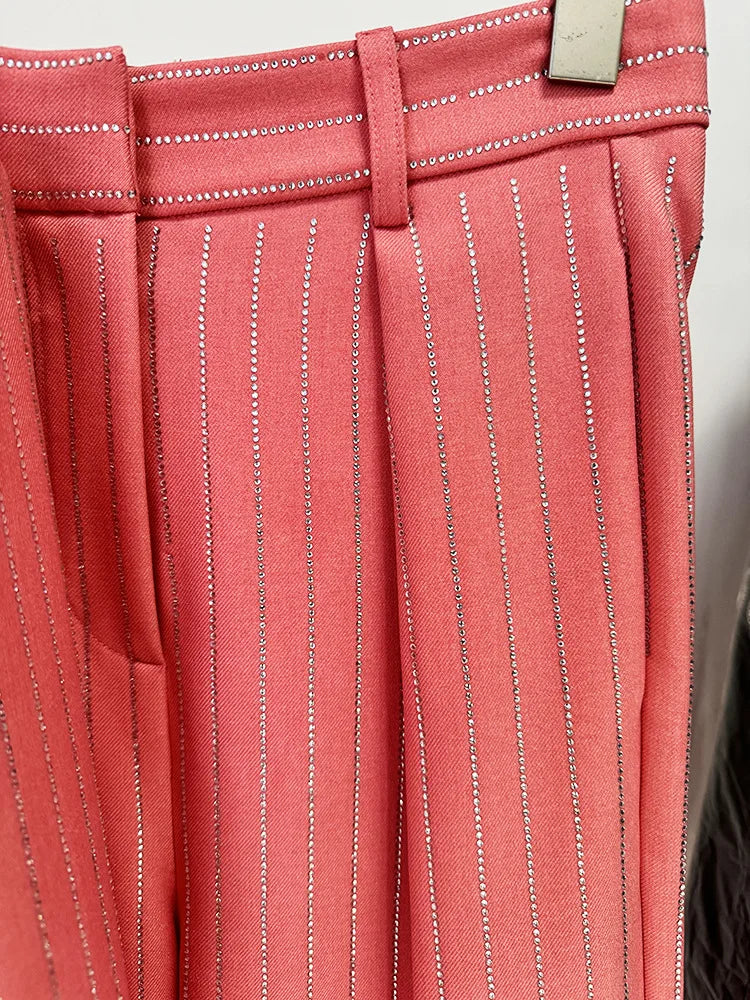 Close-up of a pink pinstripe skirt with a belt buckle.