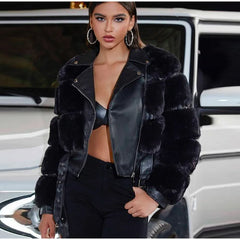 Woman wearing a black fur-trimmed leather jacket in front of a car.