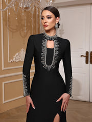 Woman wearing a black dress with intricate silver detailing in an elegant indoor setting.