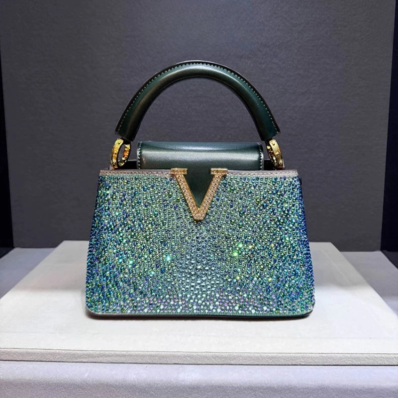 Green iridescent crystal embellished structured bag with top handle.