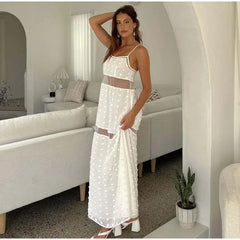 Woman in a white dress standing in a modern living room.