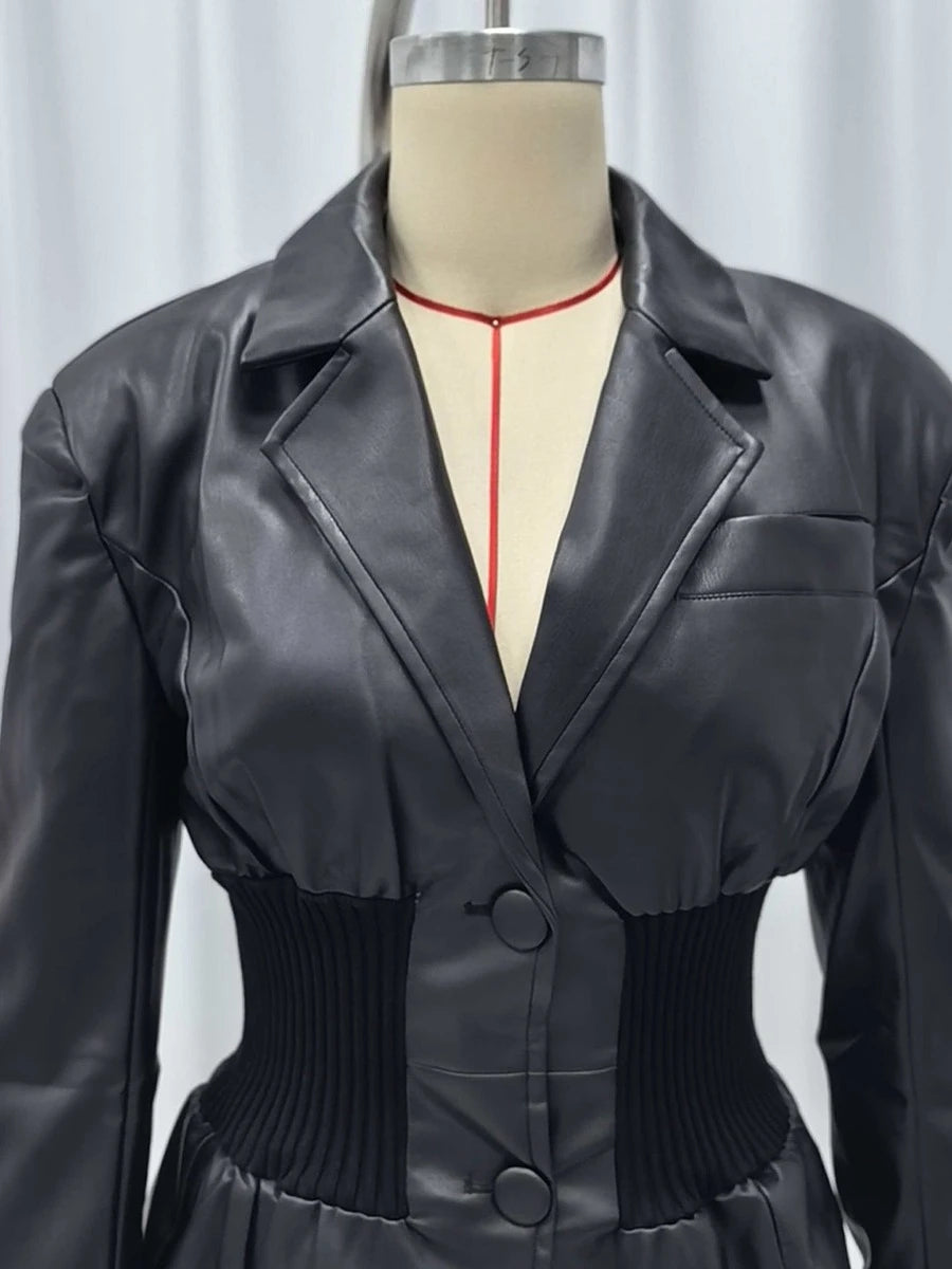 Black leather jacket on a mannequin against a plain background