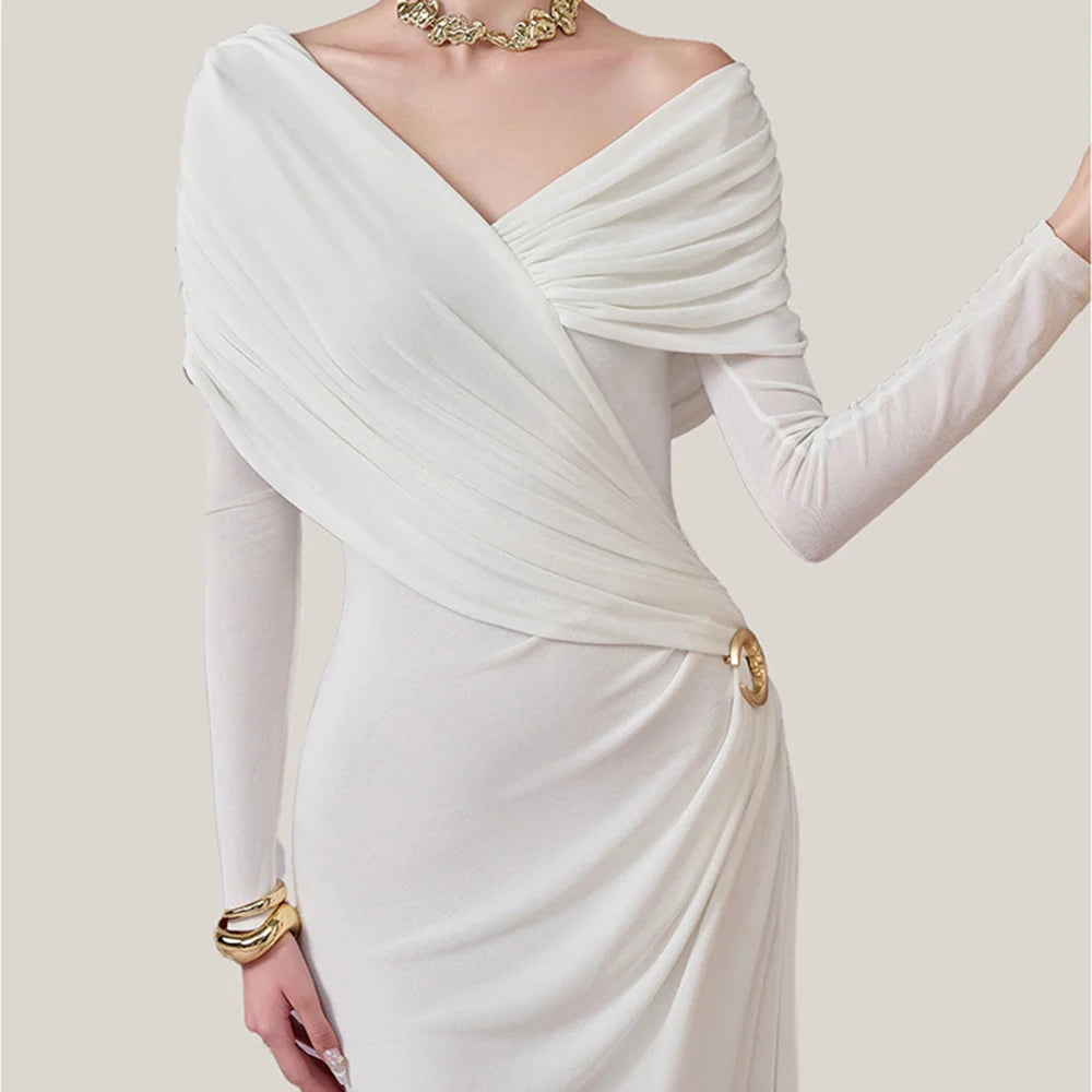 White evening gown with long sleeves on a plain background