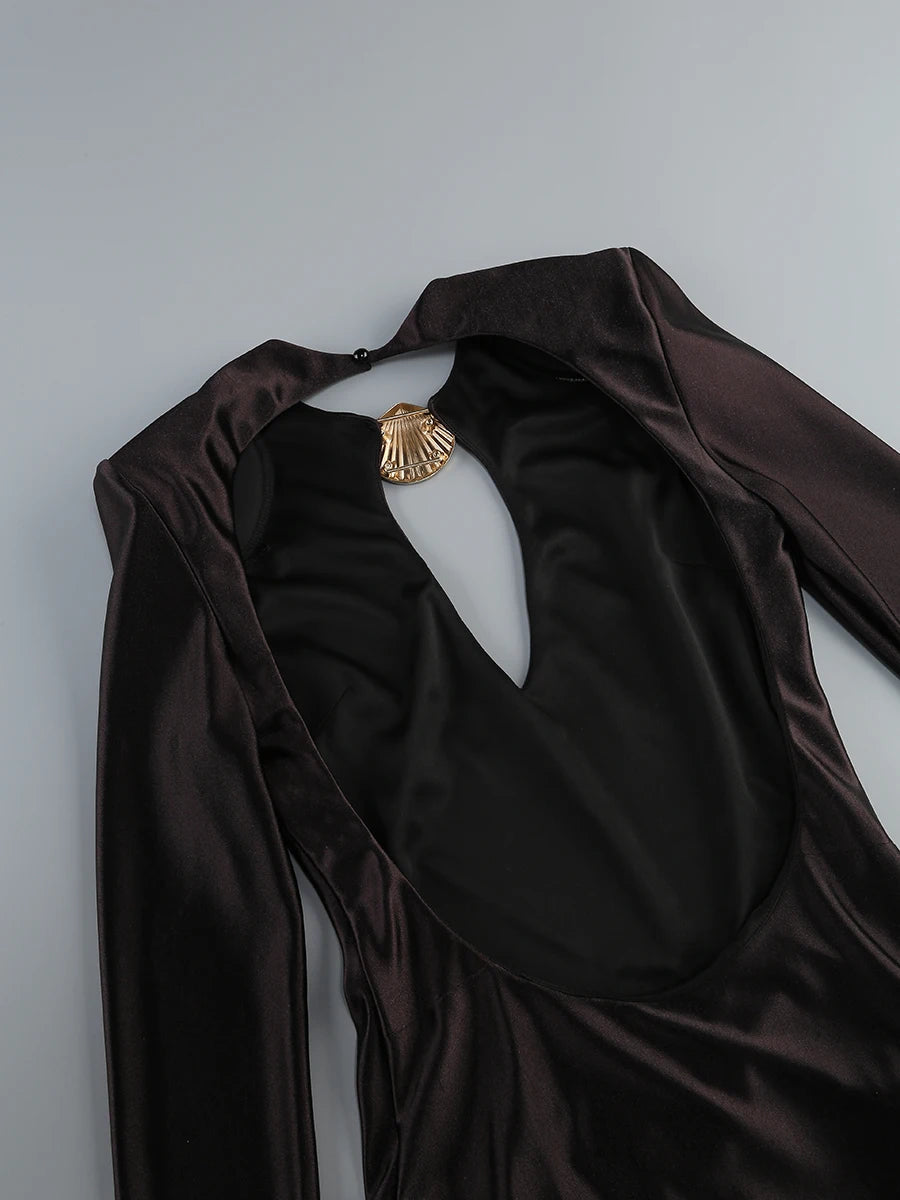 Brown satin garment with a gold brooch on a light gray background