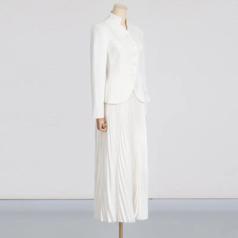 White dress on a mannequin against a plain background