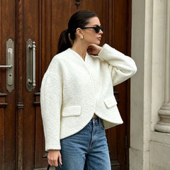 Model wearing a textured white V-neck cropped blazer.