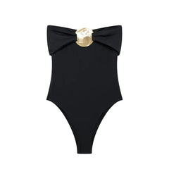 Black swimsuit with a gold bow on a white background