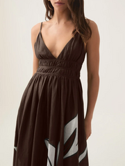 Close-up of the V-neck and shirring detail on a brown floral print maxi dress