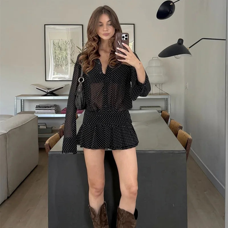 Woman taking a mirror selfie in a modern living room.