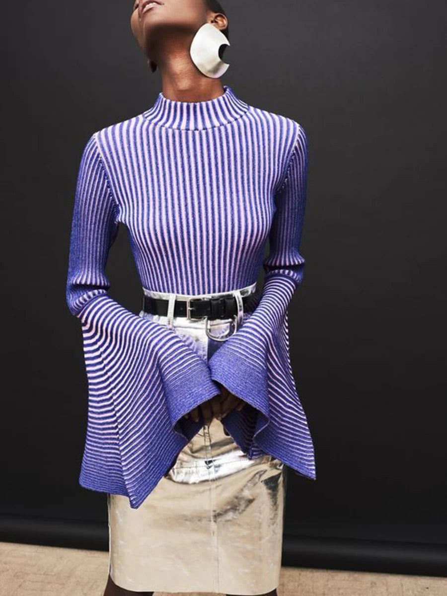 Person wearing a blue and white striped top with a black background