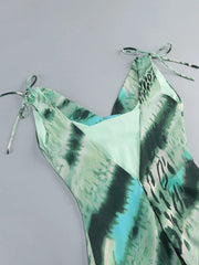 Green and black patterned halter top on a gray background