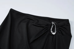 Black skirt with a silver embellishment on a white background