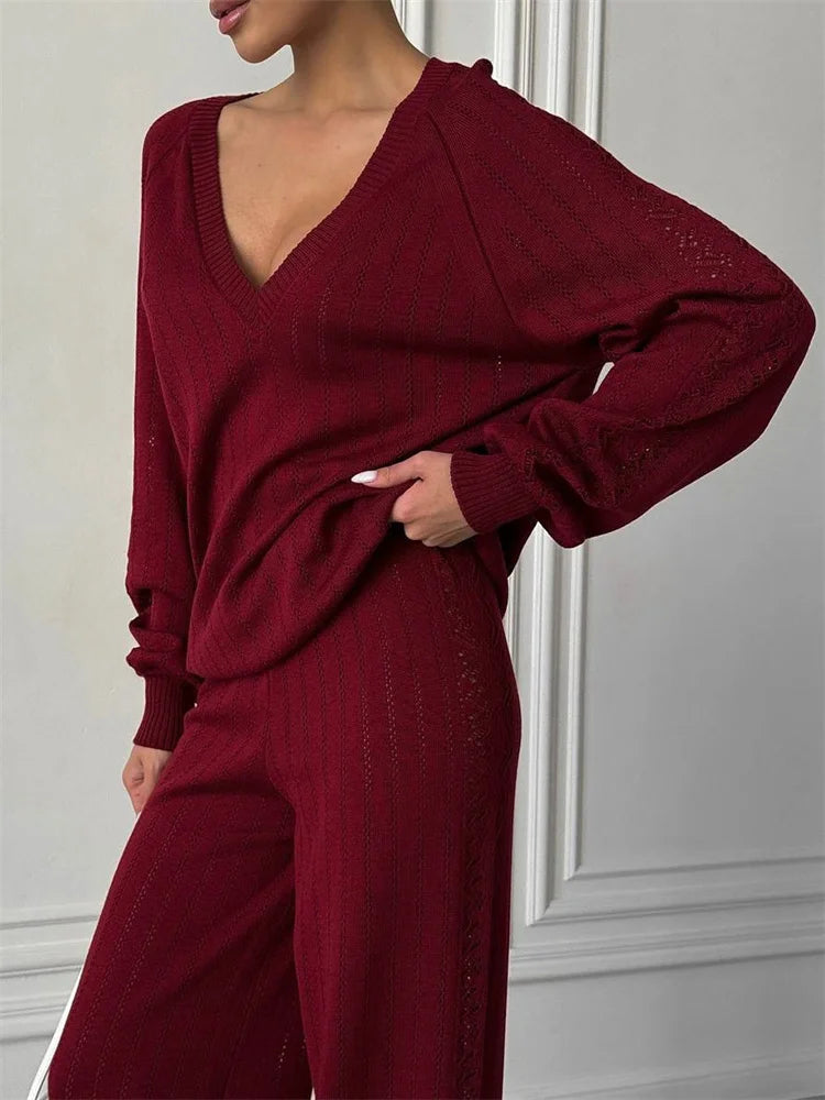 Maroon outfit worn by a person against a white wall