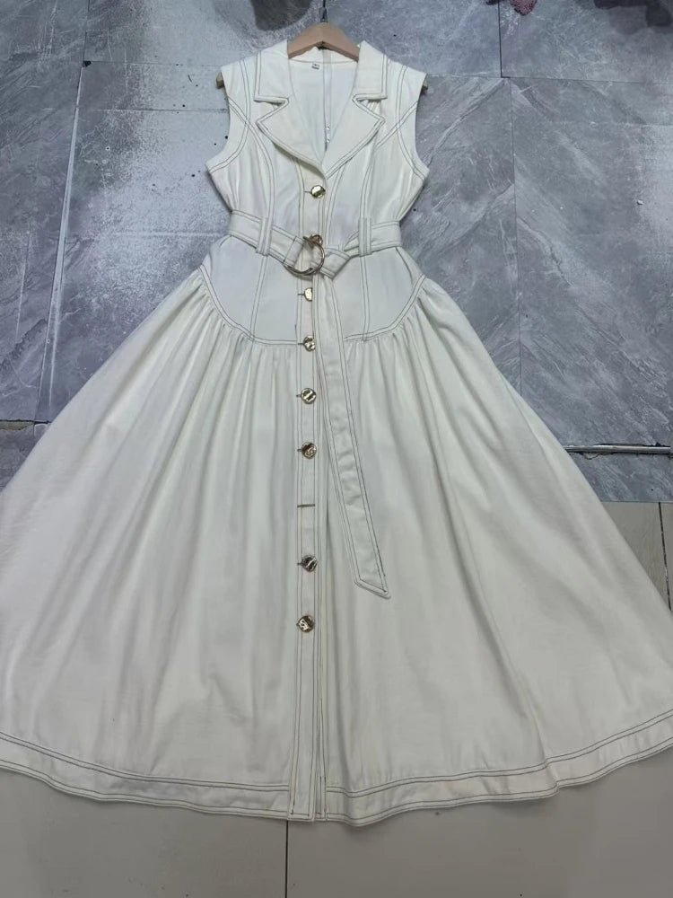 Light-colored dress with buttons on a textured gray background