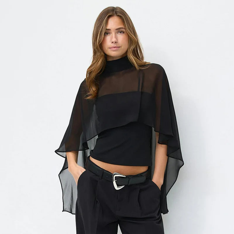 Sheer cape overlay high neck top worn by a model