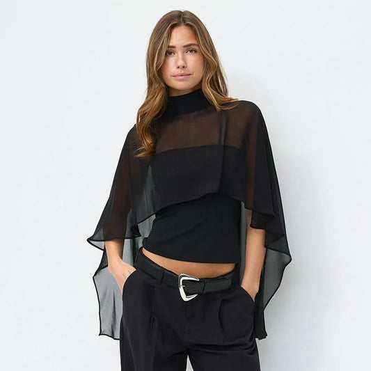 Sheer cape overlay high neck top worn by a model