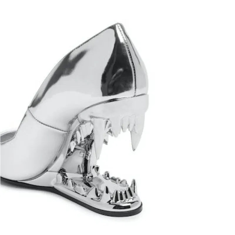 Silver high-heeled shoe with unique design on a white background