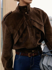 Brown corduroy jacket worn by a person with a blurred background