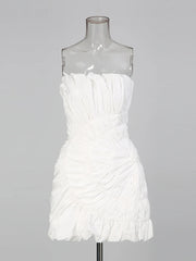 White strapless dress on a mannequin against a gray background