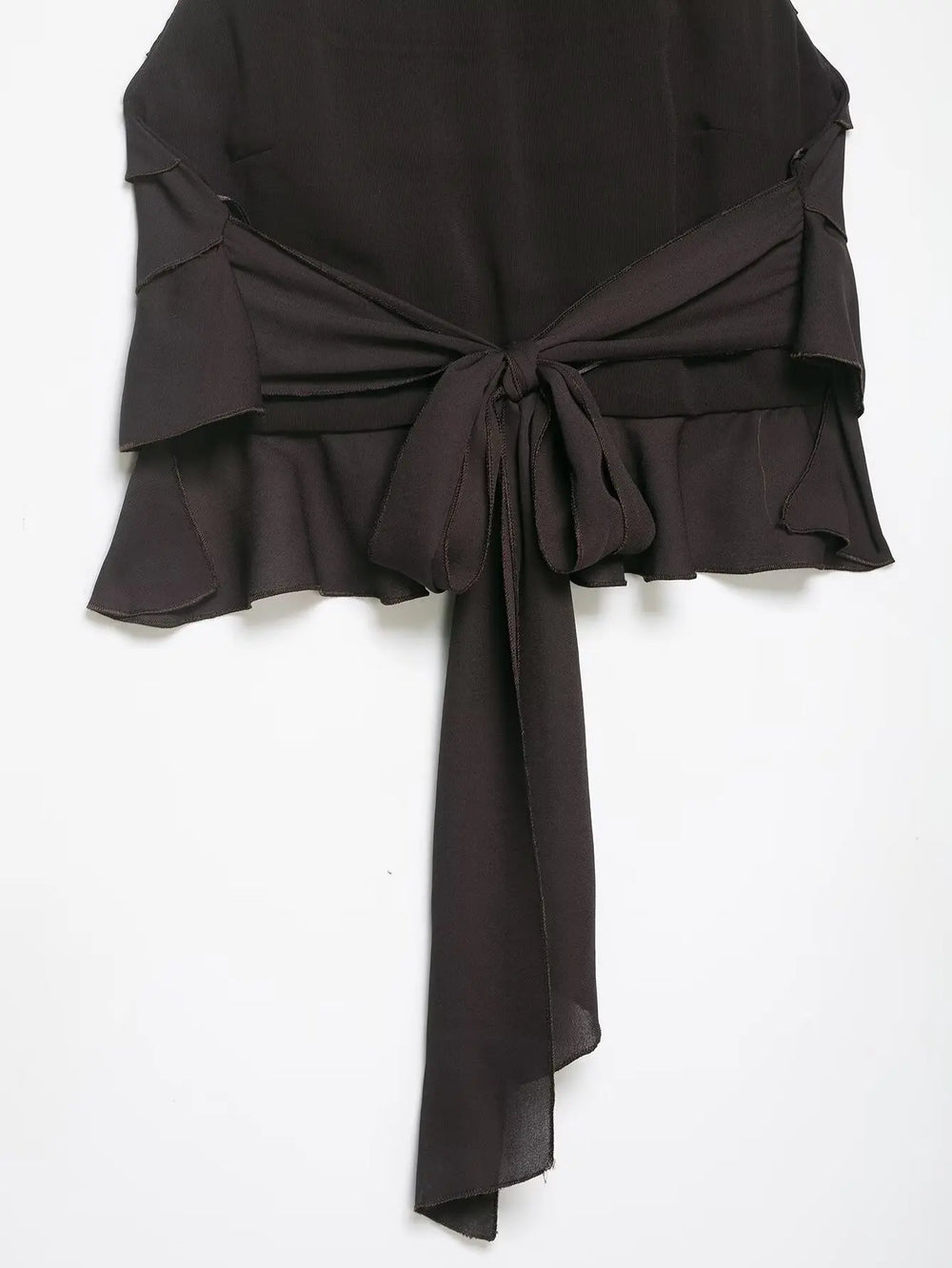 Black strapless top with ruffled details on a white background
