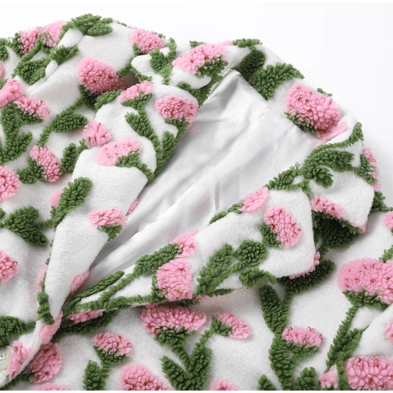 Floral patterned fabric with pink flowers and green leaves on a white background