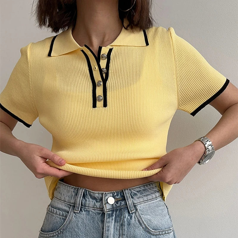 Close-up of yellow ribbed knit polo collar cropped top showing texture and buttons