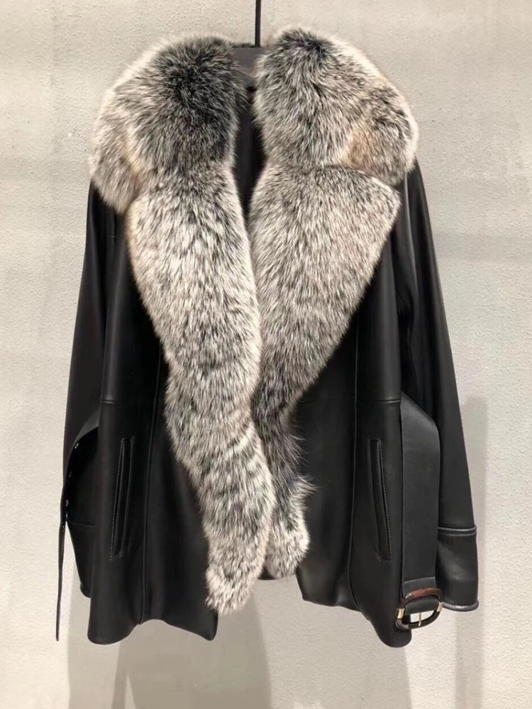 Black leather jacket with fur collar on a neutral background